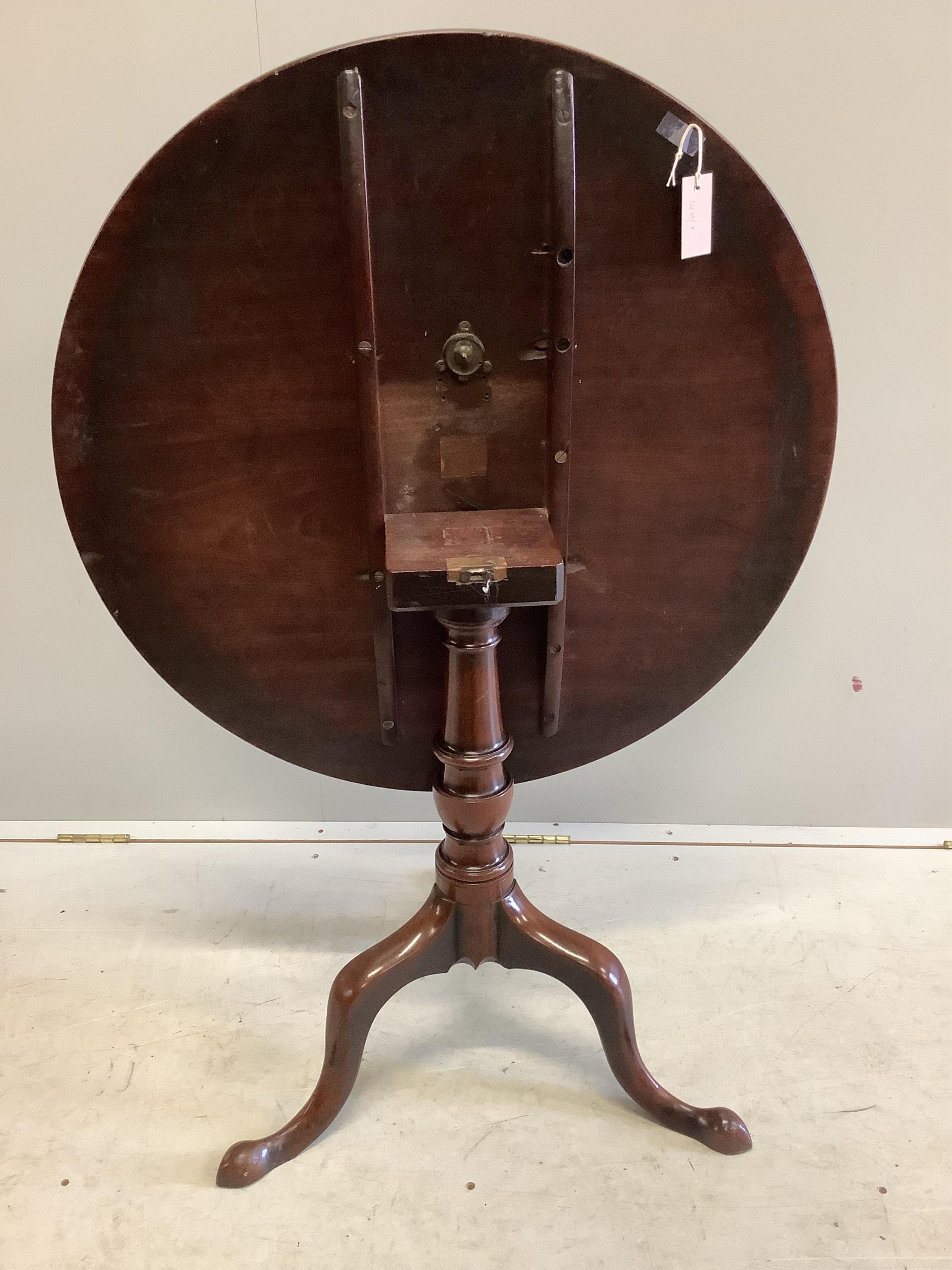 A George III circular mahogany tilt top tripod tea table, diameter 79cm, height 70cm. Condition - fair to good